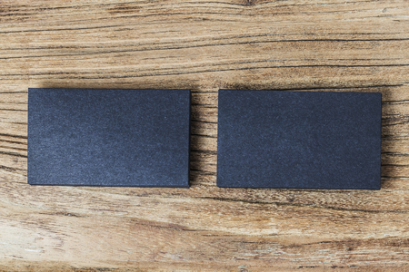 stack of blank black business cards on wooden background stock photo