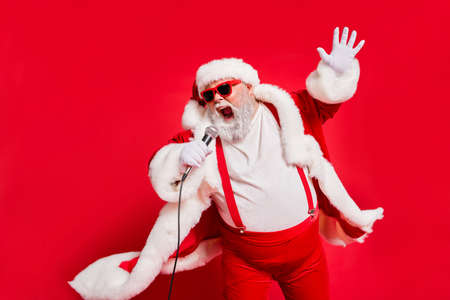 Closeup photo of funny funky wild vocalist screaming in microphone wearing fur coat gloves suspenders isolated bright background