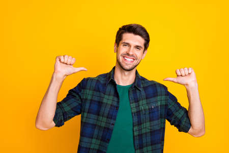 I am best. photo of amazing guy indicating thumb fingers on himself wear casual checkered shirt isolated yellow color background Stock Photo