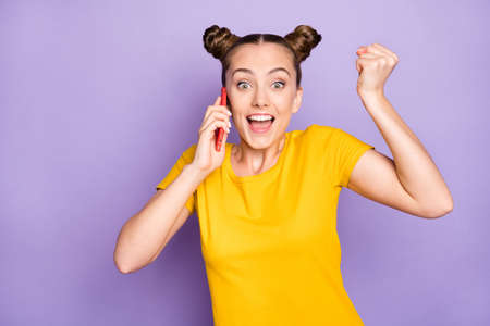 Great news. photo of pretty lady holding telephone speaking with partners excited with working achievement wear yellow t-shirt isolated on pastel purple background