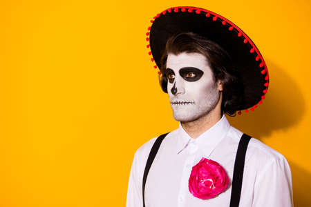 Photo of frightening ghost guy stare look empty space waiting dead men monster creatures marching wear white shirt death costume sugar skull suspenders isolated yellow color background Stock Photo