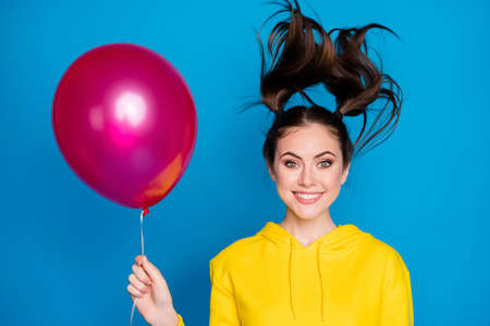 Close-up portrait of her she nice attractive lovely pretty cute delighted glad cheerful cheery girl holding in hand air ball good mood isolated on bright vivid shine vibrant blue color background