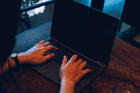Newsletter concept hand of businessman checking message box on digital laptop vintage tone filter