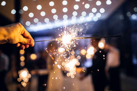 Sparkler burns in hand.happy new year 2022