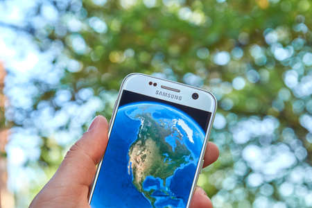 logo samsung: MONTREAL, CANADA - MAY 23, 2016 : Google Earth application on Samsung S7 screen. Google Earth is a virtual globe, map and geographical information program that was originally called EarthViewer 3D.