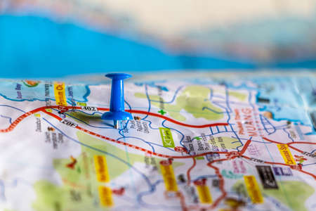 travel destination pin points on a map with colorful thumbtacks