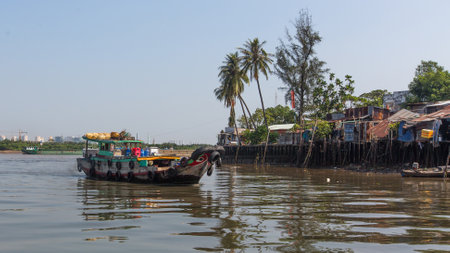 The landscape of Saigon: HO CHI MINH, VIETNAM - JAN 11, 2016: Views of the citys Slums from the river. Although the city takes up just 0.6% of the countrys land area, it contains 8.34% of the population of Vietnam. biên tập