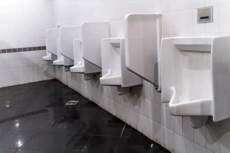 closeup white urinals in mens bathroom design of white ceramic urinals for men in toilet - Mens Bathroom closeup white urinals in mens bathroom design of white ceramic urinals for men in toilet - Mens Bathroom