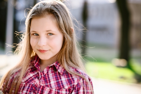 portrait of happy blond hair ten years old blue eyed girl stock