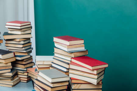 Stacks of books in the university library on a green background