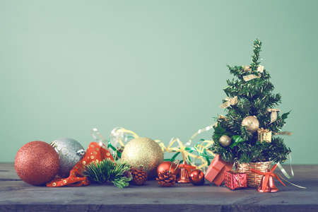 Festive Christmas Tree Stands On Dark Boards. Christmas Background Festive Christmas tree stands on dark boards. Christmas background. Christmas decorations on a green - Festive Christmas Tree Stands On Dark Boards. Christmas Background