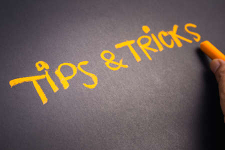 hand writing text tips and tricks on chalkboard stock photo picture