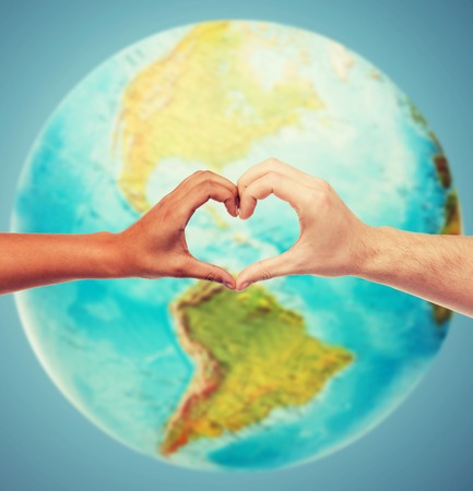 people, peace, love, life and environmental concept - close up of human hands showing heart shape gesture over earth globe and blue background - 54830732