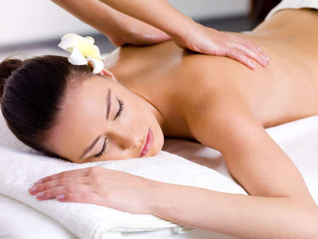 Beautiful woman having relaxing massage on her back in spa salon - 9195367