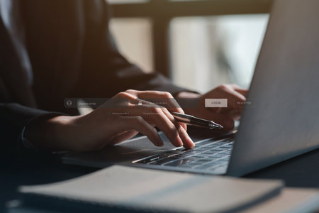 An individual is typing on a keyboard laptop showing a hologram interface to a member login a businessman is going to access the company s membership system check the information of the parties Stock Photo