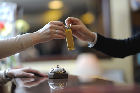 business woman  at the reception of a hotel checking in
