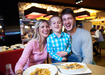 family together have break at lunch in shopping mall - 46536025