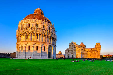 Sunset view of baptistery of st. john (battistero di san giovanni di pisa), pisa cathedral (duomo di pisa) with the leaning tower of pisa (torre di pisa) on piazza dei miracoli in pisa, tuscany, italy