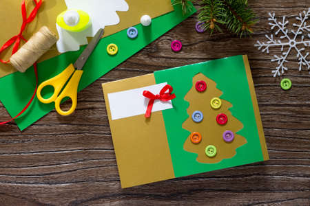 stock photo the child create christmas greeting cards paper festive fir in christmas tree toys glue scissors paper leaves thread on a wooden table - Create Christmas Cards stock photo the child create christmas greeting cards paper festive fir in christmas tree toys glue scissors paper leaves thread on a wooden table - Create Christmas Cards