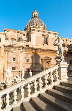View of saint catherine church with the marble statue of the pretoria fountain ahead, palermo, sicily, italy
