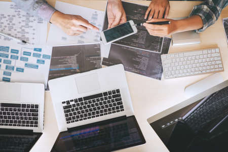 Professional developer programmer cooperation meeting and brainstorming and programming in website working a software outsourcing and coding technology writing codes and database Stock Photo