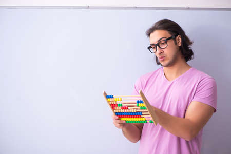 Young male student in front of board