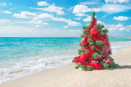 christmas tree with red decorations on the sea beach christmas vacation concept stock photo - Beach Christmas christmas tree with red decorations on the sea beach christmas vacation concept stock photo - Beach Christmas