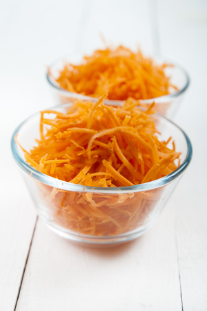 Grate Carrots In A Bowl On White Wooden Table Tasty And Healthy Food Grate Carrots In A Bowl On White Wooden Table Tasty And Healthy Food