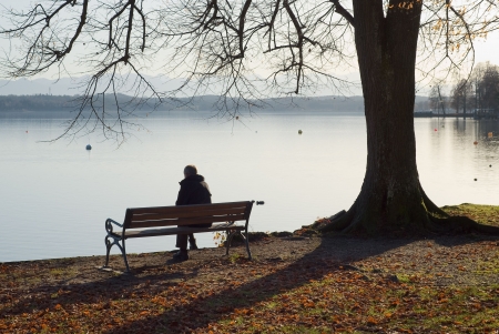 sad lonely: Lonely Man Sitting Next to a Lake