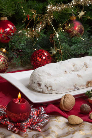 Traditional German Christmas Cake Cranberry Stollen Christmas Tree Ornaments And Candles Stock Traditional German Christmas Cake Cranberry Stollen Christmas Tree Ornaments And Candles Stock