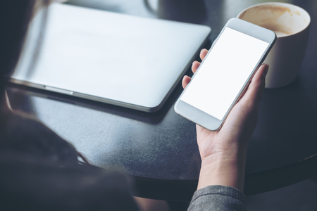 mockup image of mobile phone with blank white screen with latop