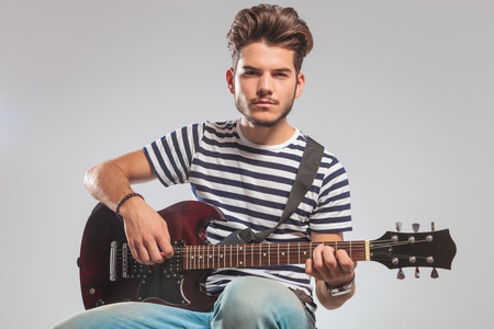 片足上げ よそ見しながらギターを保持でポーズを下から上方に若いギタリストのスタジオ ポートレート の写真素材 画像素材 Image 片足上げ よそ見しながらギターを保持でポーズを下から上方に若いギタリストのスタジオ ポートレート の写真素材 画像素材 Image