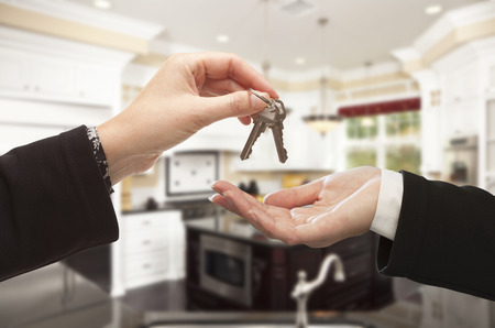 Handing Over New House Keys Inside Beautiful Custom Built Home Stock Photo Handing Over New House Keys Inside Beautiful Custom Built Home Stock Photo
