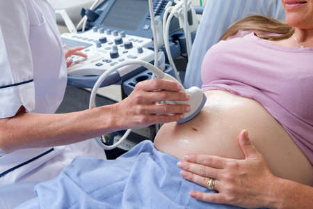 prenatal checkup close up nurse performing ultrasound on pregnant woman in hospital lang_evoimages - Prenatal Nurse prenatal checkup close up nurse performing ultrasound on pregnant woman in hospital lang_evoimages - Prenatal Nurse