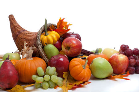 An overflowing cornucopia including pumpkins, grapes, gourds and leaves on a white background - 20654776