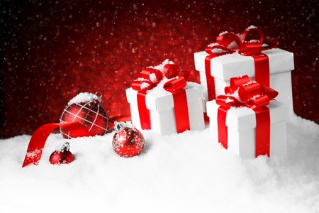 christmas gift boxes with a large red bow standing in fresh snow against a background bokeh - Large Christmas Gift Boxes christmas gift boxes with a large red bow standing in fresh snow against a background bokeh - Large Christmas Gift Boxes