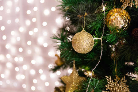 Christmas tree with toys lights garland bokeh on background