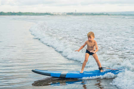 Water Board Sports >> Little Boy Surfing On Tropical Beach Child On Surf Board On Stock Water Board Sports >> Little Boy Surfing On Tropical Beach Child On Surf Board On Stock