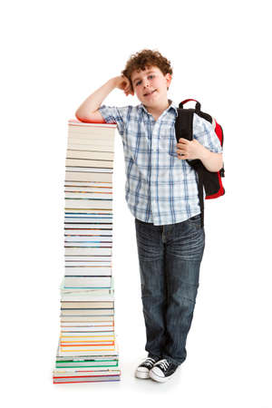 Student standing near the pile of books on white Фото со стока