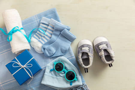 Baby boy shower concept on wooden background, copy space, top view