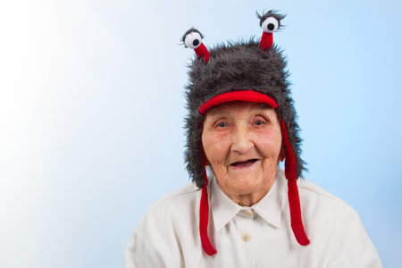 very old lady in funny fur hat with two tentacles