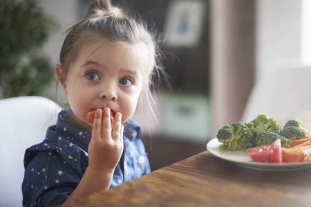 Eating vegetables by child make them healthier Stock Photo