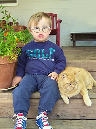 little boy sitting with cat
