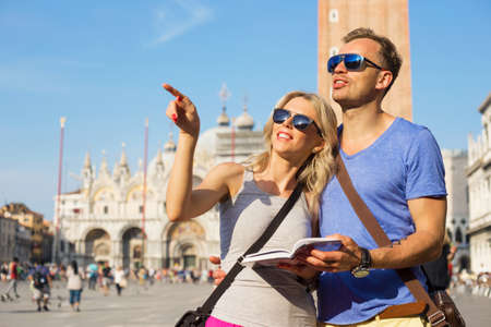 Couple Reading Tourist Guide And Sightseeing In Venice Couple Reading Tourist Guide And Sightseeing In Venice