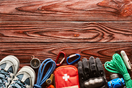 Travel items for hiking tourism still life over wooden background - 93306187