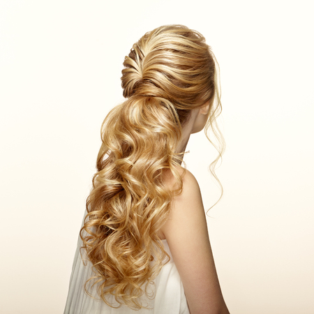 Blonde girl with long and shiny curly hair. beautiful model woman with curly hairstyle. care and beauty hair products. care and beauty of hair Banco de Imagens