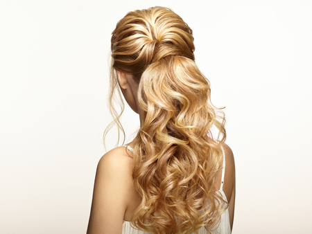 Blonde girl with long and shiny curly hair. beautiful model woman with curly hairstyle. care and beauty hair products. care and beauty of hair