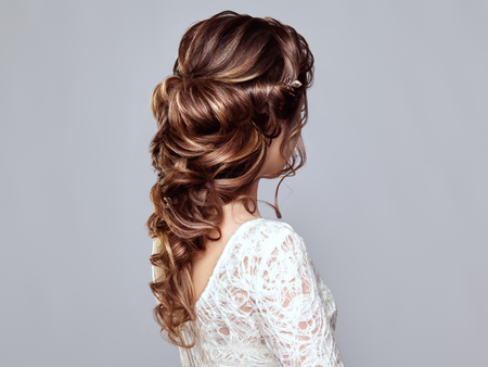 Brunette woman with long and shiny curly hair. beautiful model lady with curly hairstyle. care and beauty hair products. care and beauty of hair