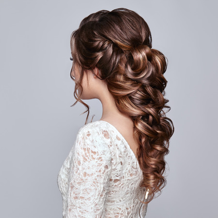Brunette woman with long and shiny curly hair. beautiful model lady with curly hairstyle. care and beauty hair products. care and beauty of hair