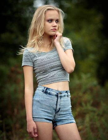 Location Portrait Of A Beautiful Young Blond Teenage Girl Alone In The Woods Wearing Denim Shorts Location Portrait Of A Beautiful Young Blond Teenage Girl Alone In The Woods Wearing Denim Shorts